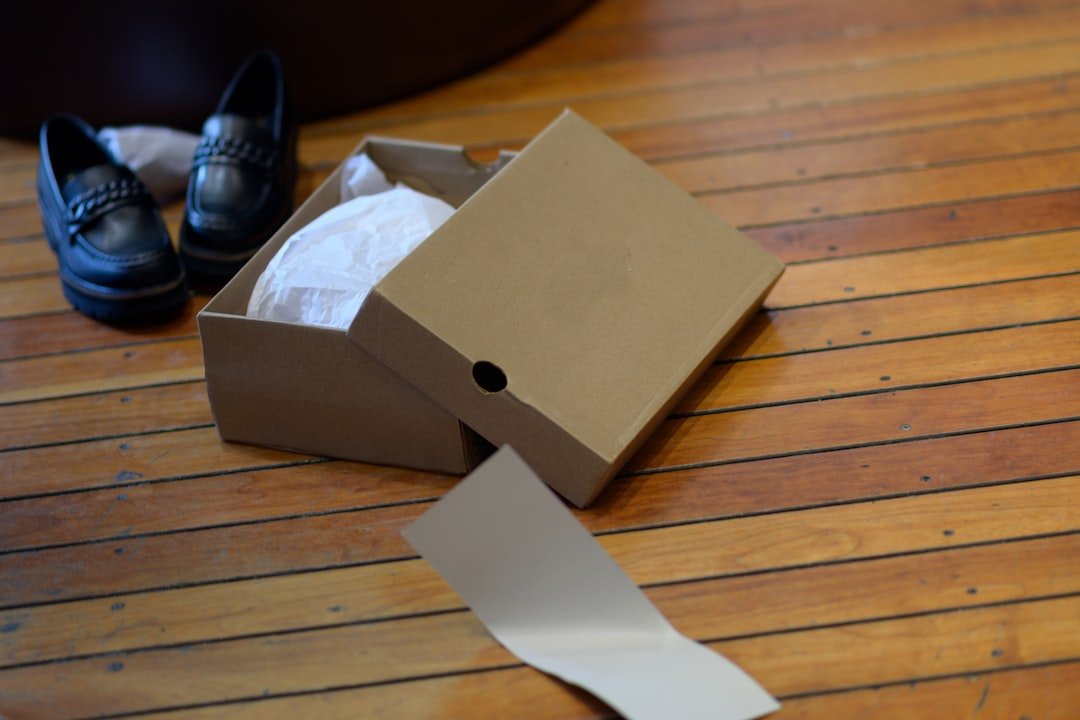 a pair of black shoes sitting on top of a wooden floor