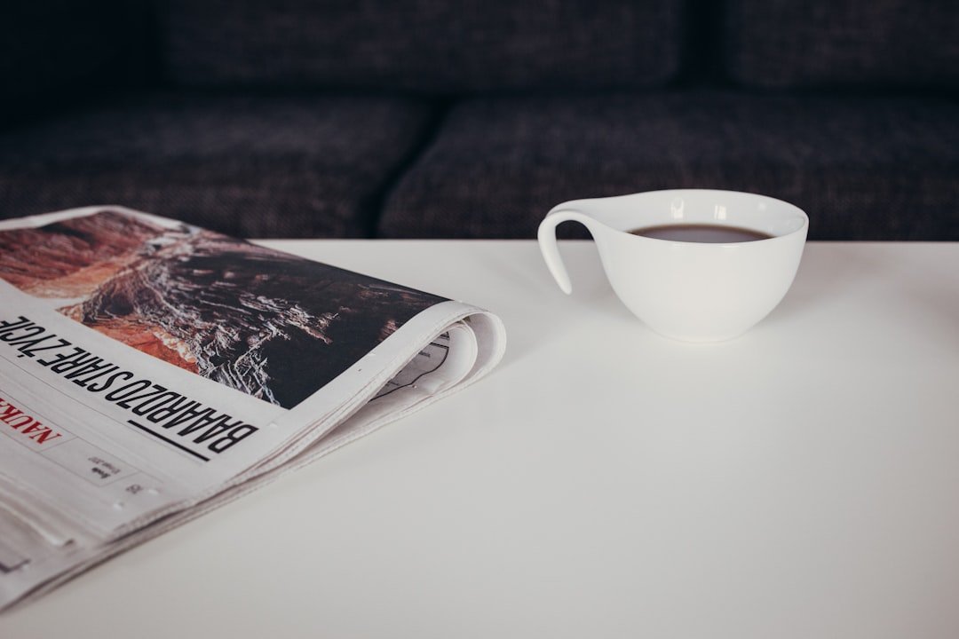 white ceramic mug on white table